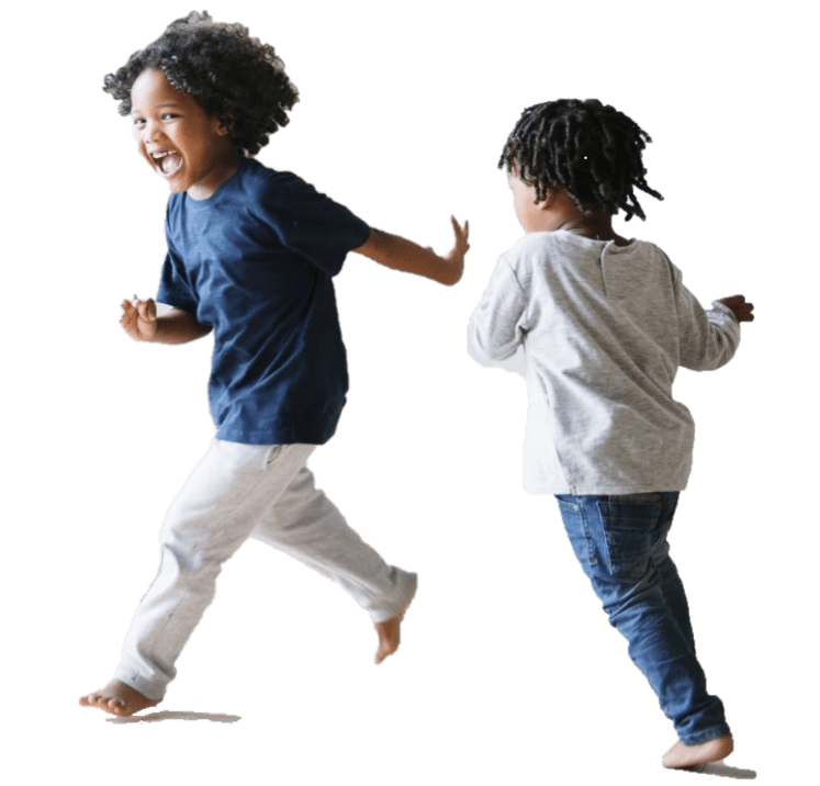 Two toddlers running and smiling in empty room