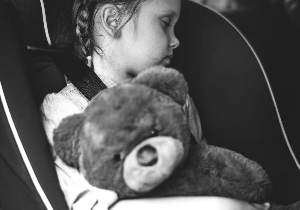 Girl asleep in car seat