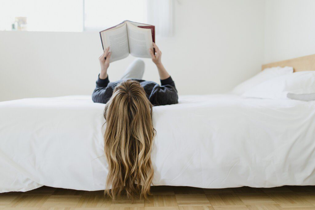 Teen reading on bed